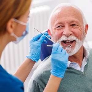 Man smiles at dental hygienist