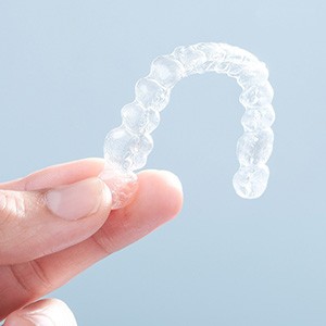Patient holding clear aligner