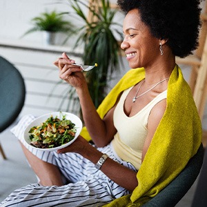 Smiling woman enjoying nutrient-dense meal outside