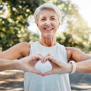 Lady makes shape of heart with her hands