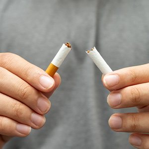 Closeup of patient breaking cigarette