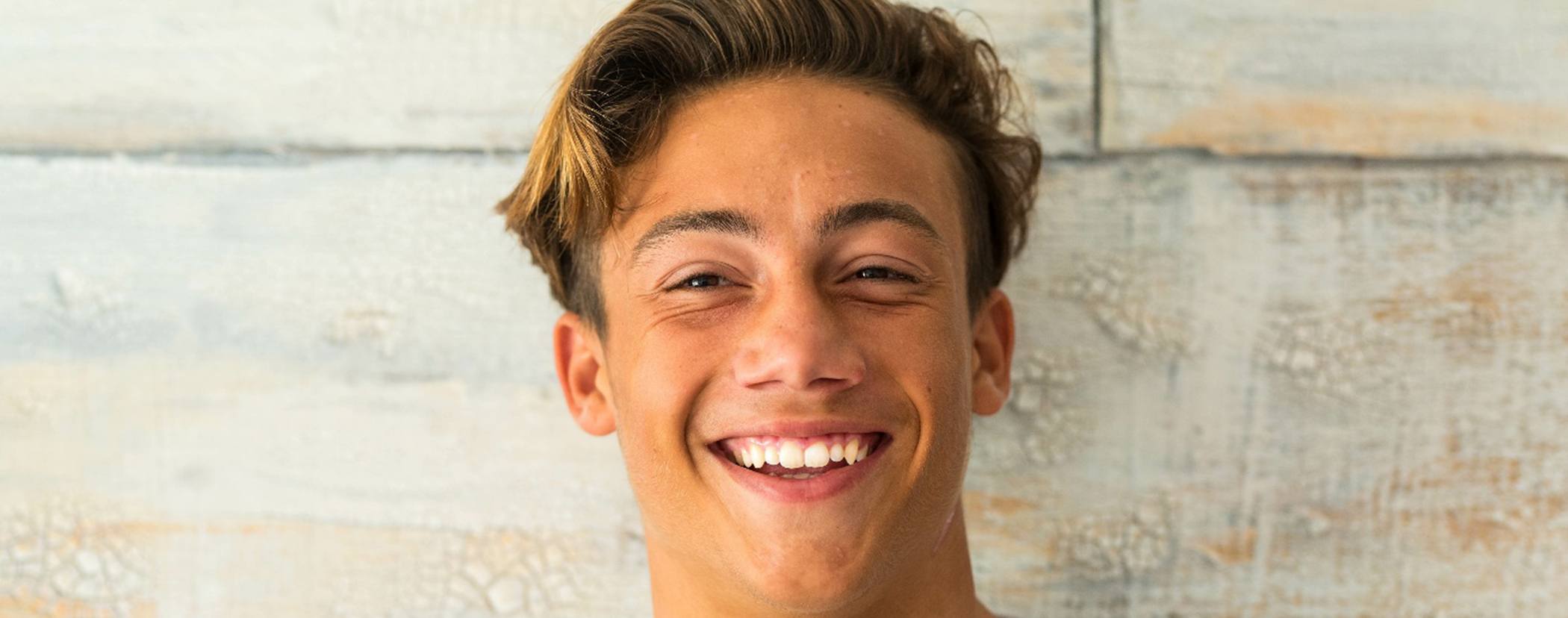 Male teenager smiling after receiving children’s dentistry in Sterling Heights