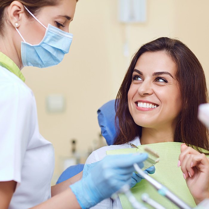 Dental crown resting on a fingertip