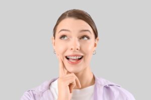 Smiling young woman with braces 