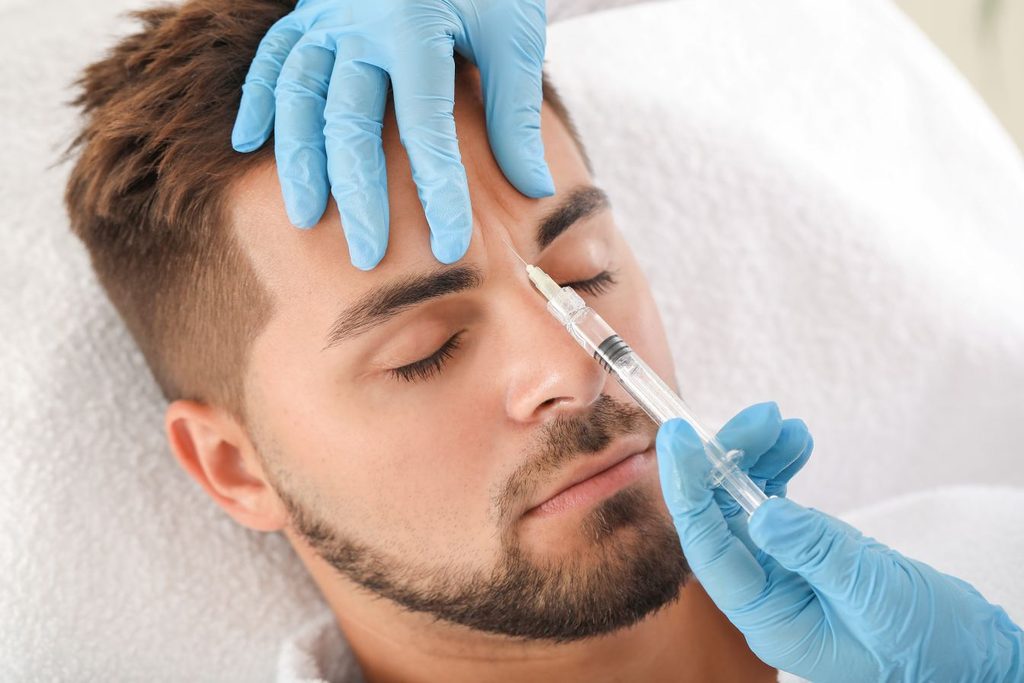 A man getting BOTOX in his glabellar lines.