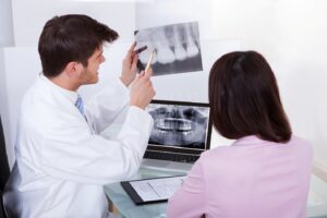 Dentist showing patient an X-ray.